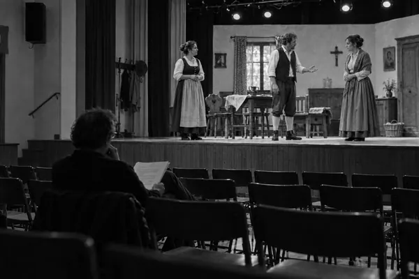 Generalprobe einer Theatergruppe, der Regisseur sitzt allein im leeren Saal